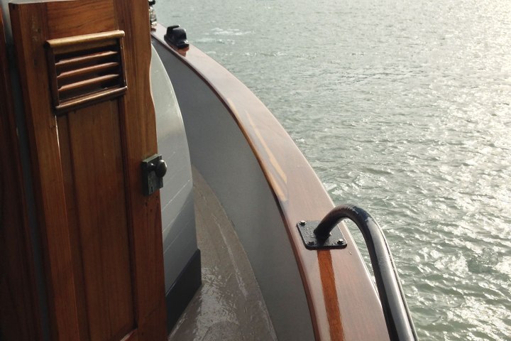 The side of a boat over the water