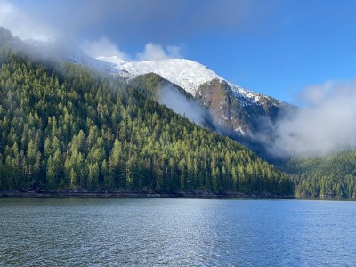 a body of water with a mountain in the background
