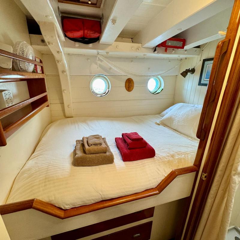 a bedroom with a bed and desk in a room