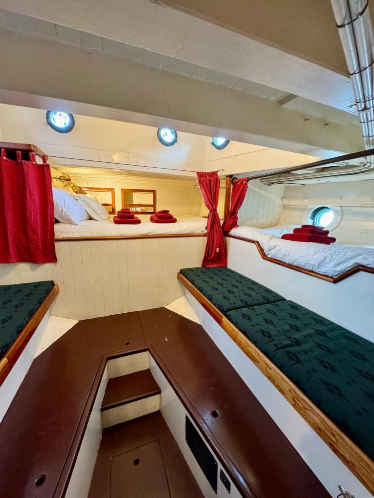 a bedroom with a bed and desk in a room