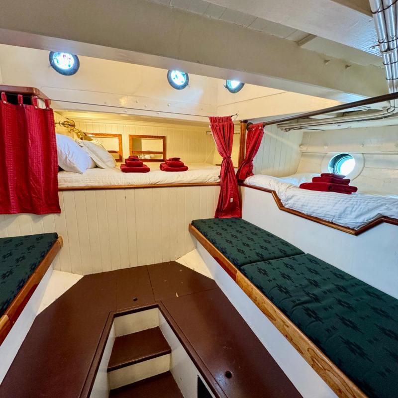 a bedroom with a bed and desk in a room