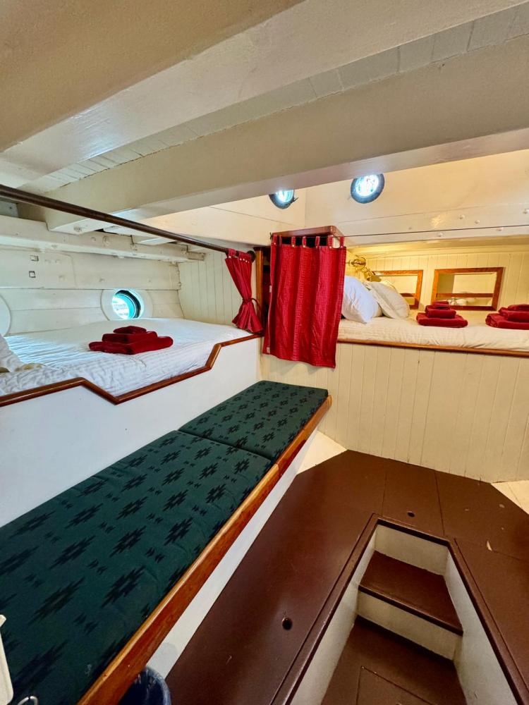 a bedroom with a bed and desk in a room