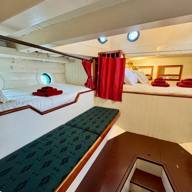 a bedroom with a bed and desk in a room