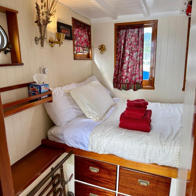 a bedroom with a bed and desk in a room