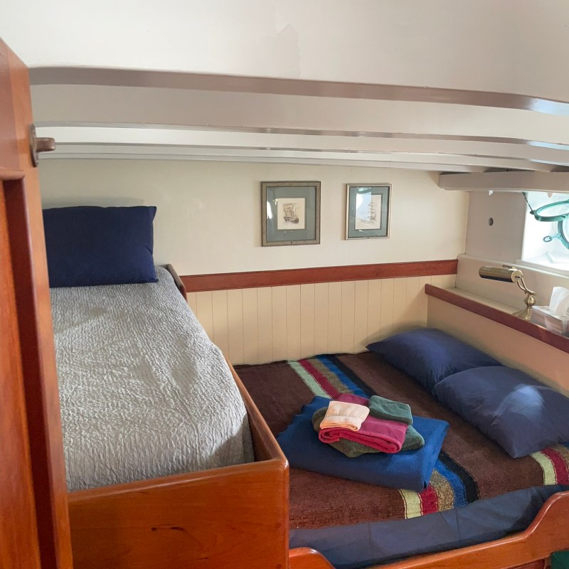 a bedroom with a bed and desk in a room