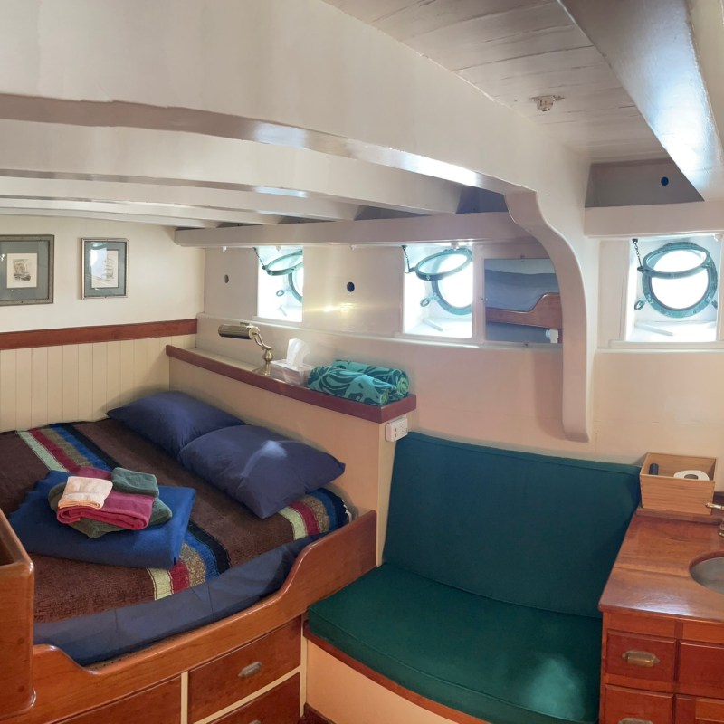 a bedroom with a bed and desk in a small room